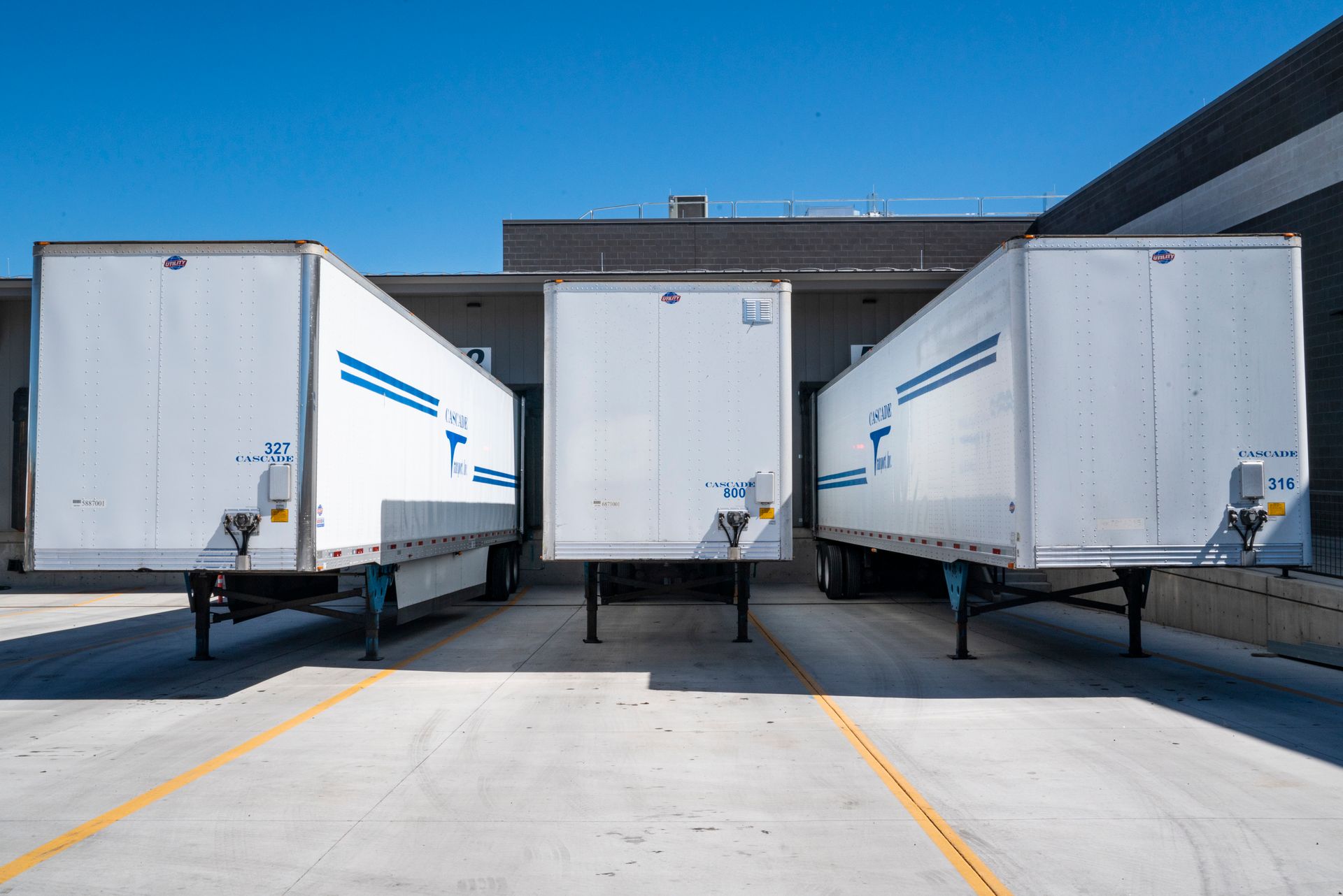White enclosed trailers at an industrial shipping dock