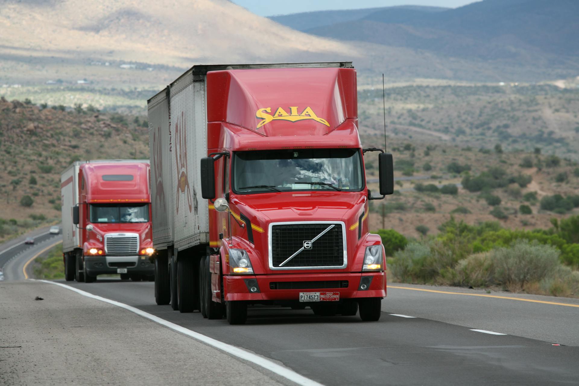 Semi-trucks on a highway between facilities