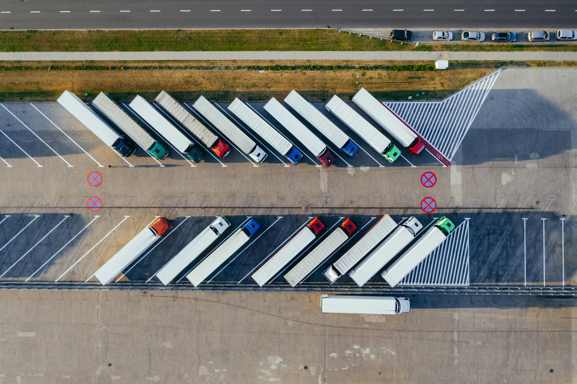 Semi-trucks parked in a staging lot