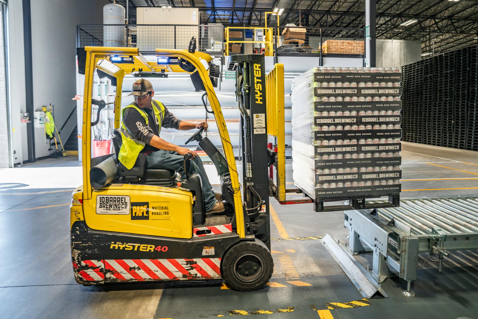 Forklift operator moving freight at dock