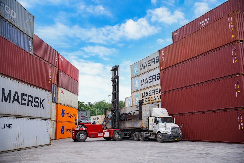 Forklift moving pallets at dock