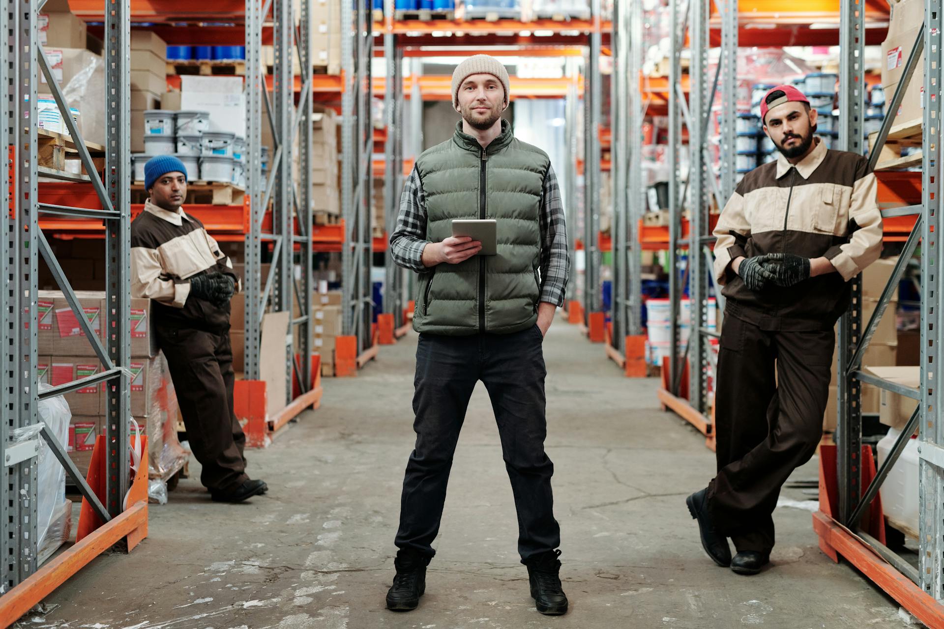 Logistics team in a warehouse corridor with tablet