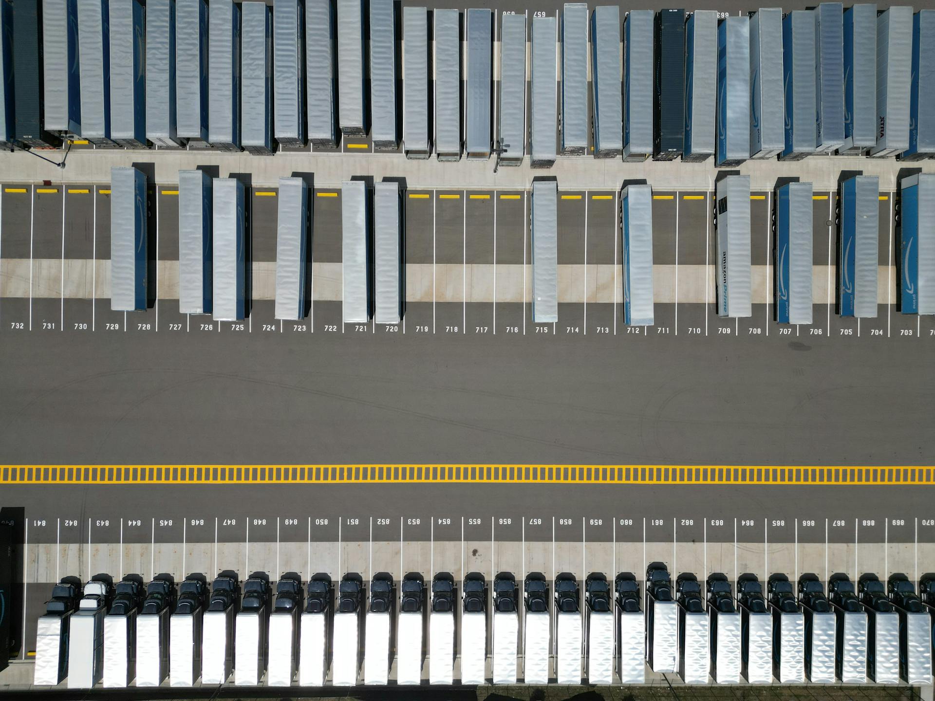 Aerial view of semi-trucks parked at a freight yard